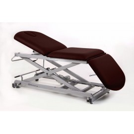 TABLE D'EXAMEN ÉLECTRIQUE 3 PANNEAUX AVEC BOUCHON FACIAL, PORTE-ROULEAUX ET ROULETTES